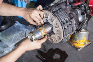 Safety wiring bolts on an aircraft brake.